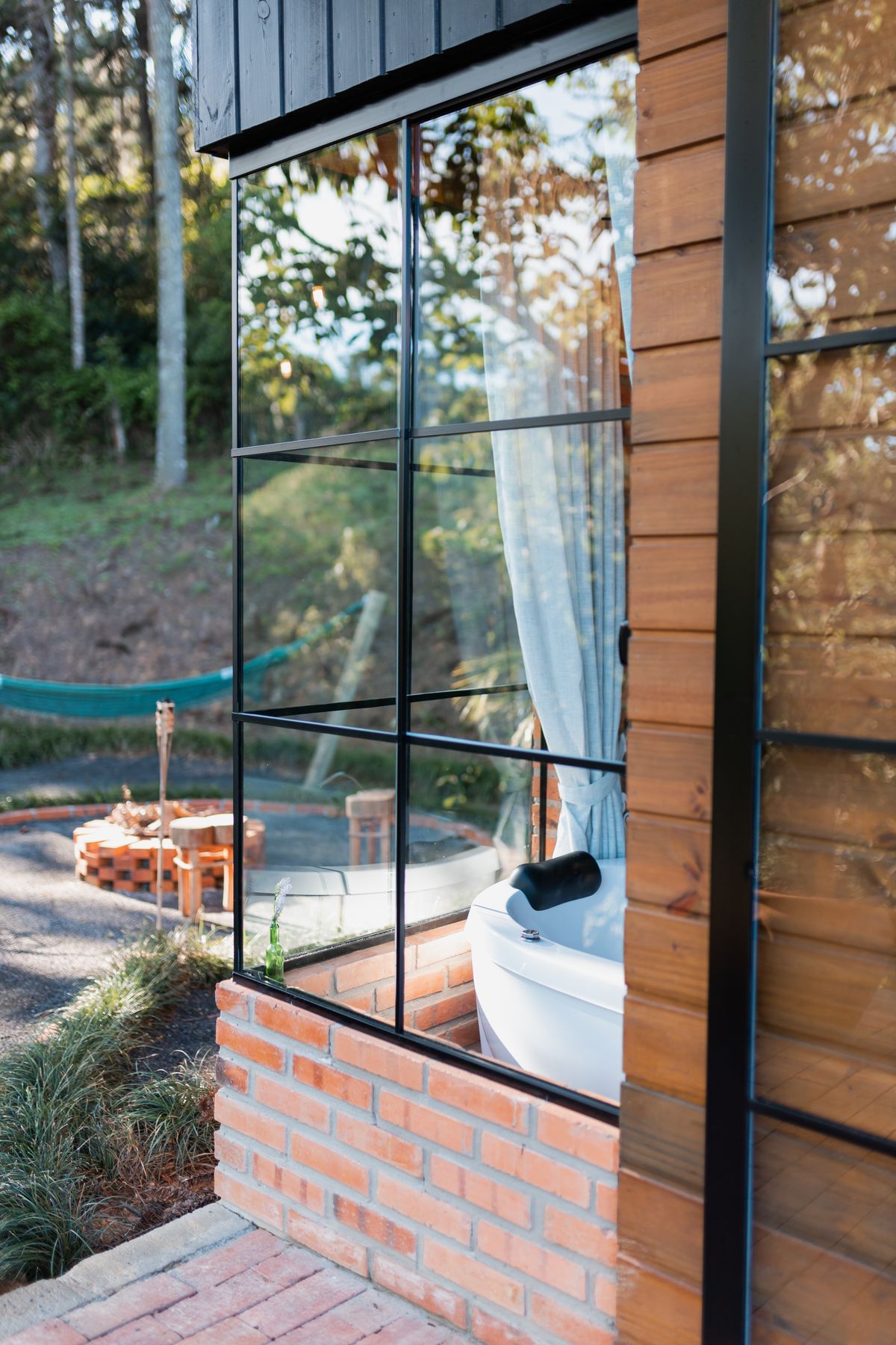 Modern outdoor cold plunge tub with glass panels
