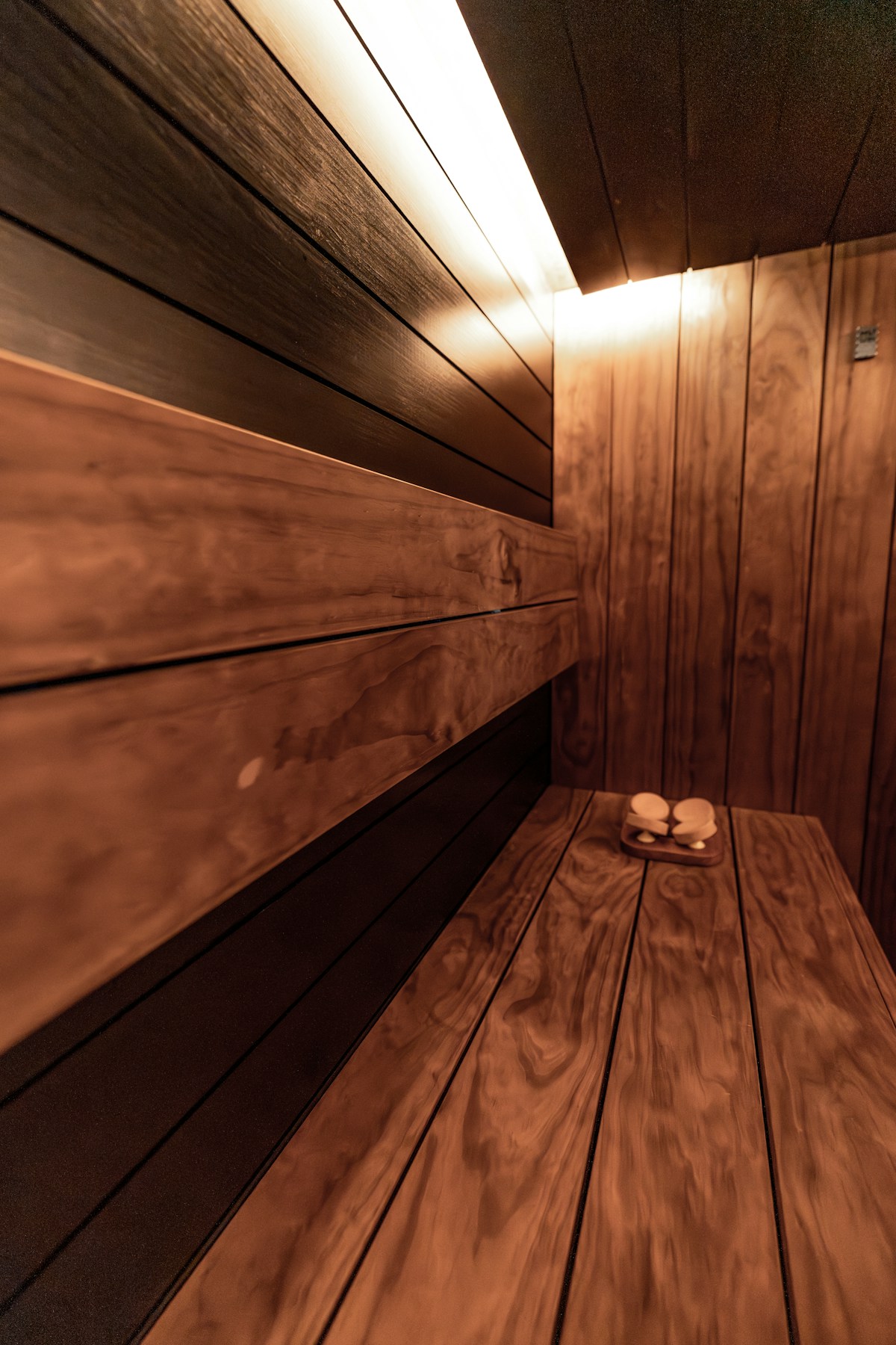 Custom cedar sauna interior with tiered benches and warm lighting