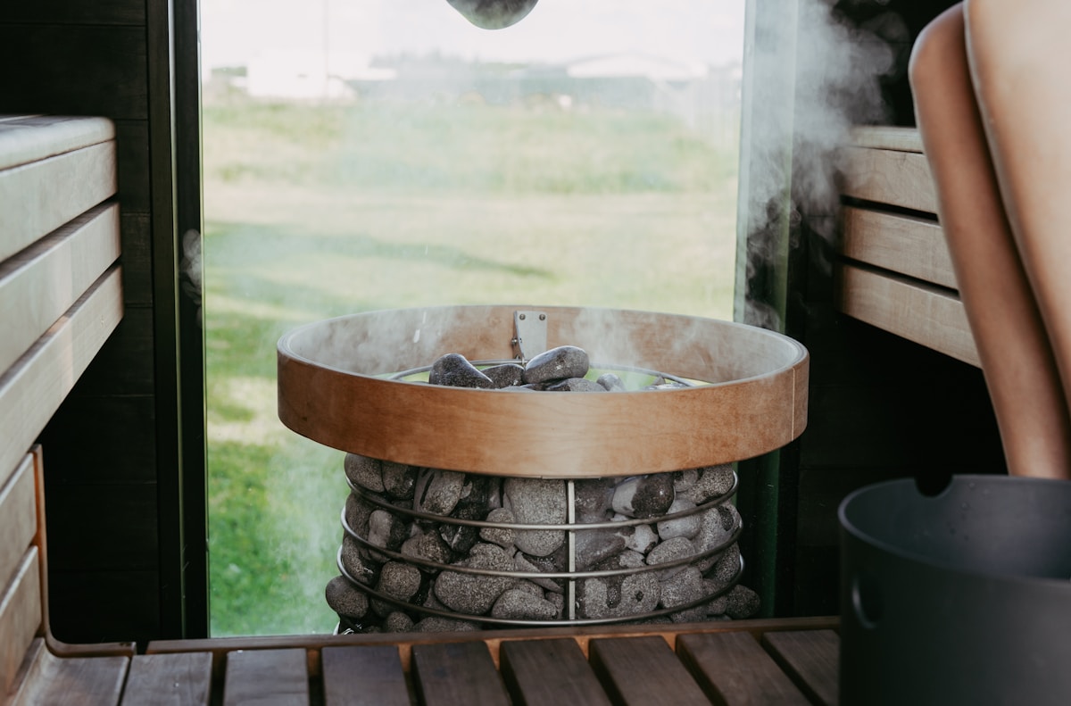 Steam rising from hot sauna stones on an electric heater