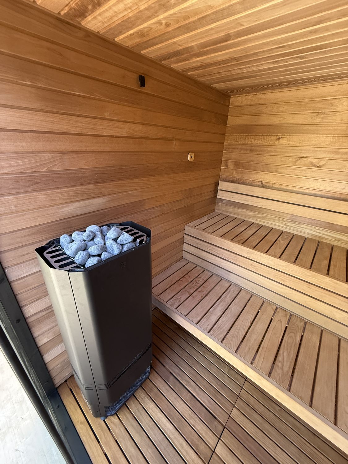 Western red cedar indoor sauna interior with tiered benches