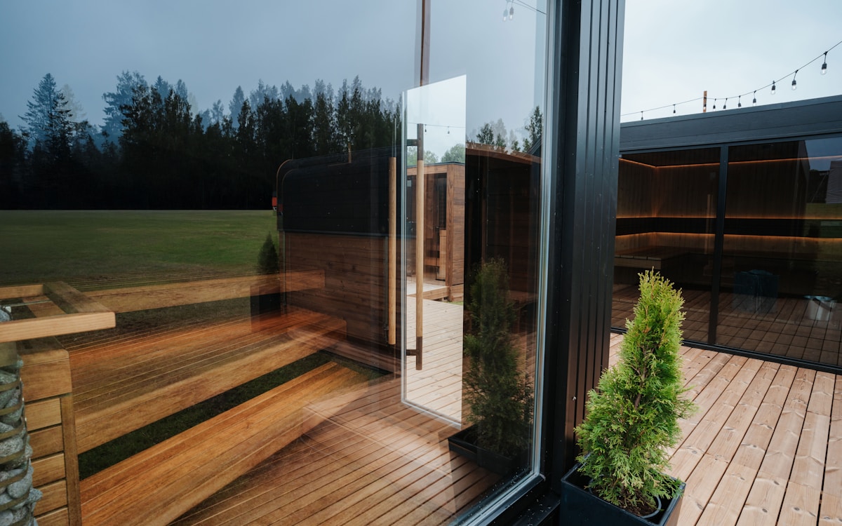 Modern outdoor sauna cabins with glass walls and cedar deck